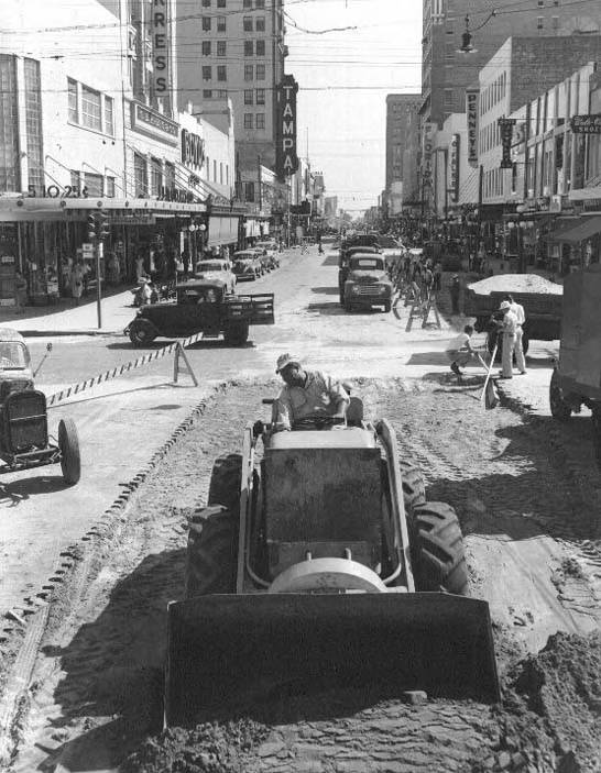 Historic loader and road crew working on a Tampa city street